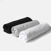 Rolled black, gray, and white towels.
