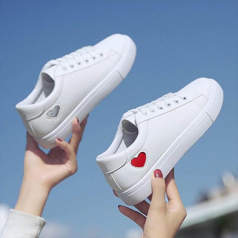 Heart Throb Kicks: Steal Hearts with Every Step Alright, check out these super cute sneakers! These white canvas kicks with red heart cutouts - Estalios