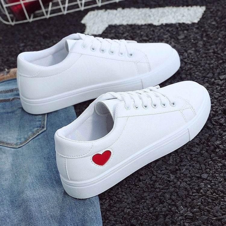 Heart Throb Kicks: Steal Hearts with Every Step Alright, check out these super cute sneakers! These white canvas kicks with red heart cutouts - Estalios