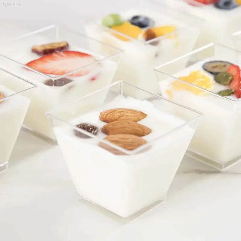 Yogurt cups with fruit and nuts.