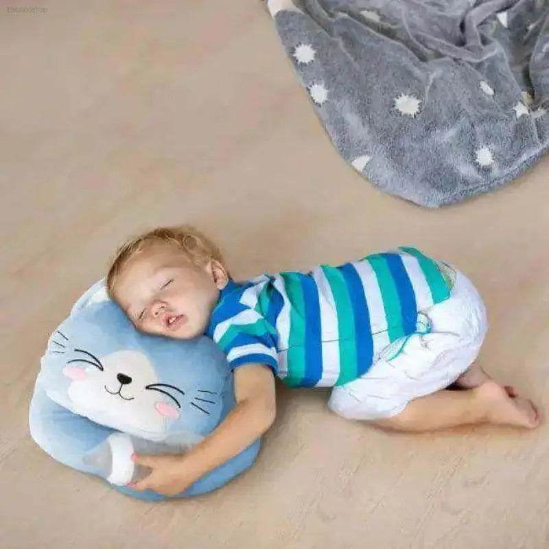 Sleeping toddler on a cat pillow.