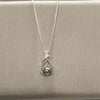 Silver necklace with pearl pendant.