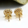Gold stud earrings.
