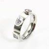 Silver ring with three embedded gemstones.