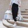 Folded white baby stroller.