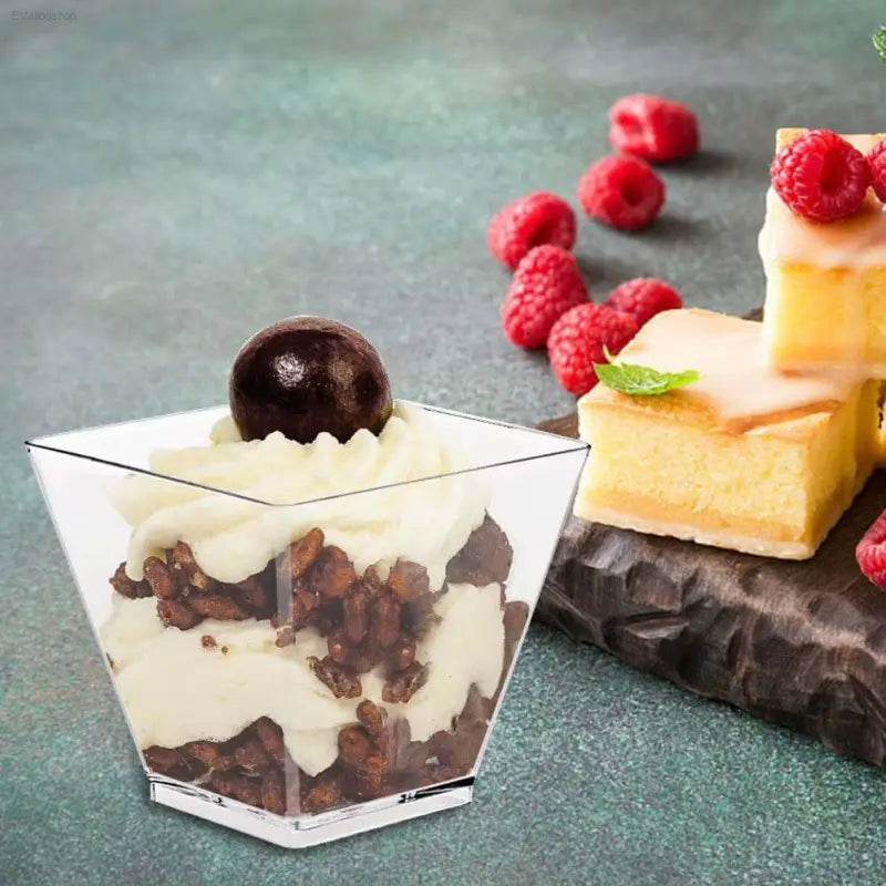 Dessert in a clear square cup.