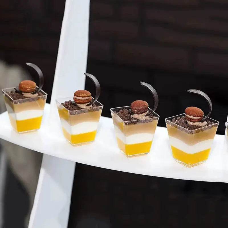 Layered dessert cups with macarons.