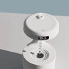 White humidifier with digital clock.