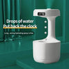 White humidifier with digital clock.