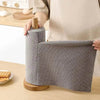 Gray fabric paper towel holder.