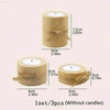 Set of three wooden candle holders with bows.