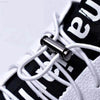 Black and white sneaker with metal lace lock.