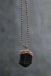 Black tourmaline pendant with copper cap and beaded chain.