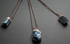 Three crystal pendant necklaces.