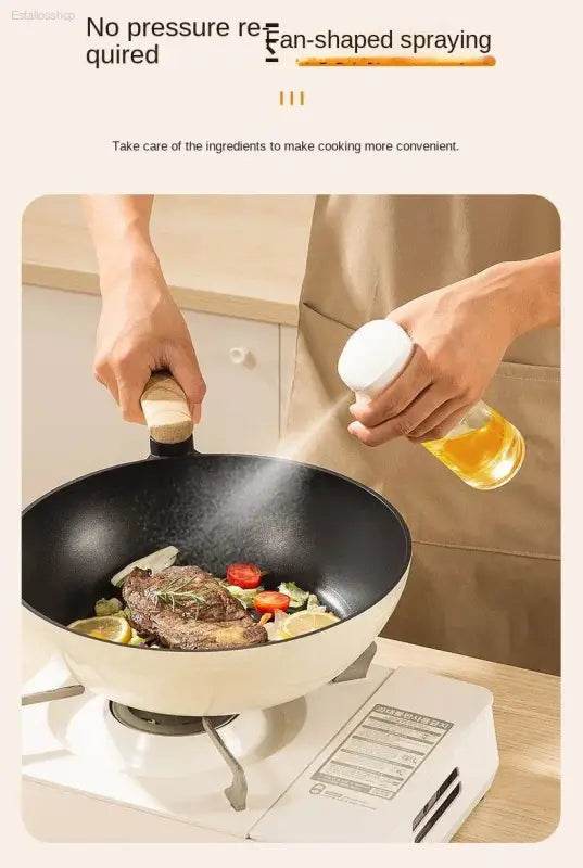 Cooking oil sprayer over a wok.
