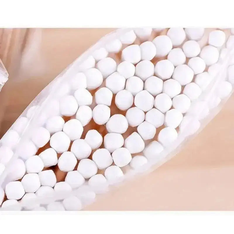 Bag of white spherical candies next to 500pcs Double Head Wood Cotton Swabs for Nose