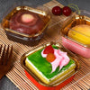 Assorted cakes in plastic containers.