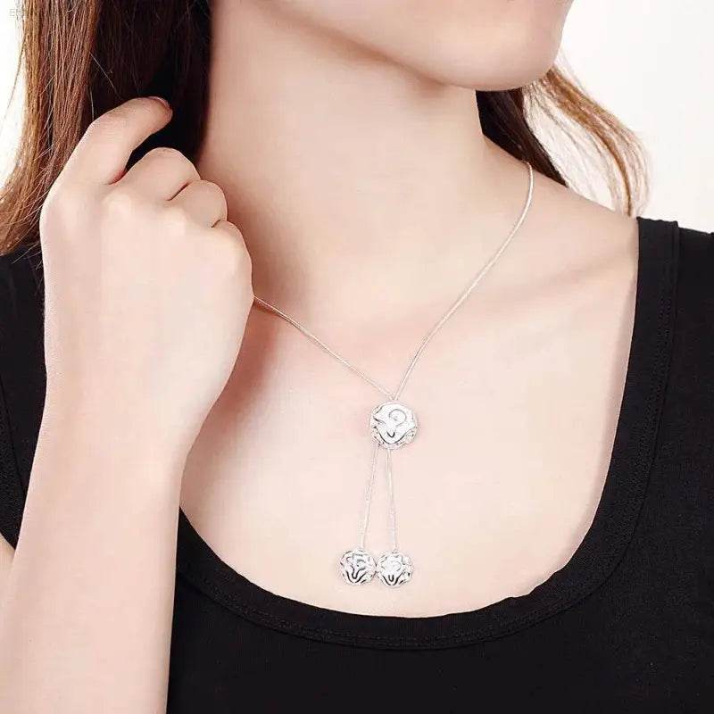 Silver-toned necklace with openwork sphere pendants.