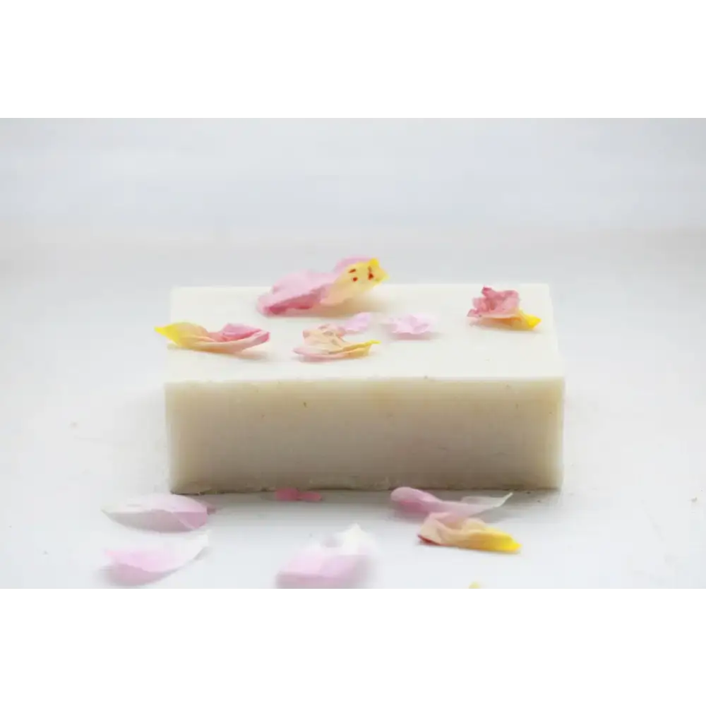 Rectangular English Rose Soap Bar surrounded by scattered flower petals