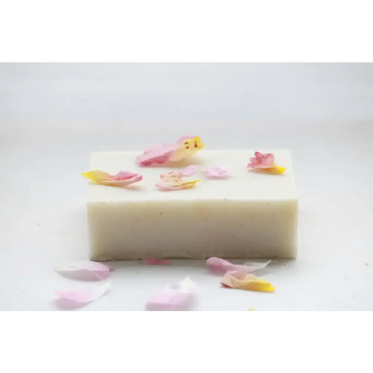 Rectangular English Rose Soap Bar surrounded by scattered flower petals