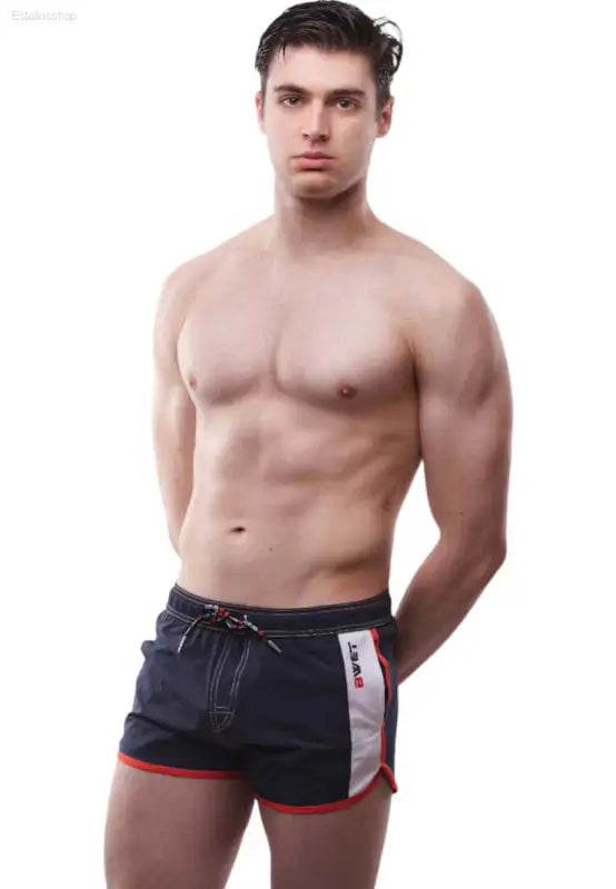 Man in navy blue swim trunks.