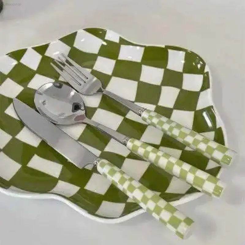 Green and white checkered plate with matching cutlery.