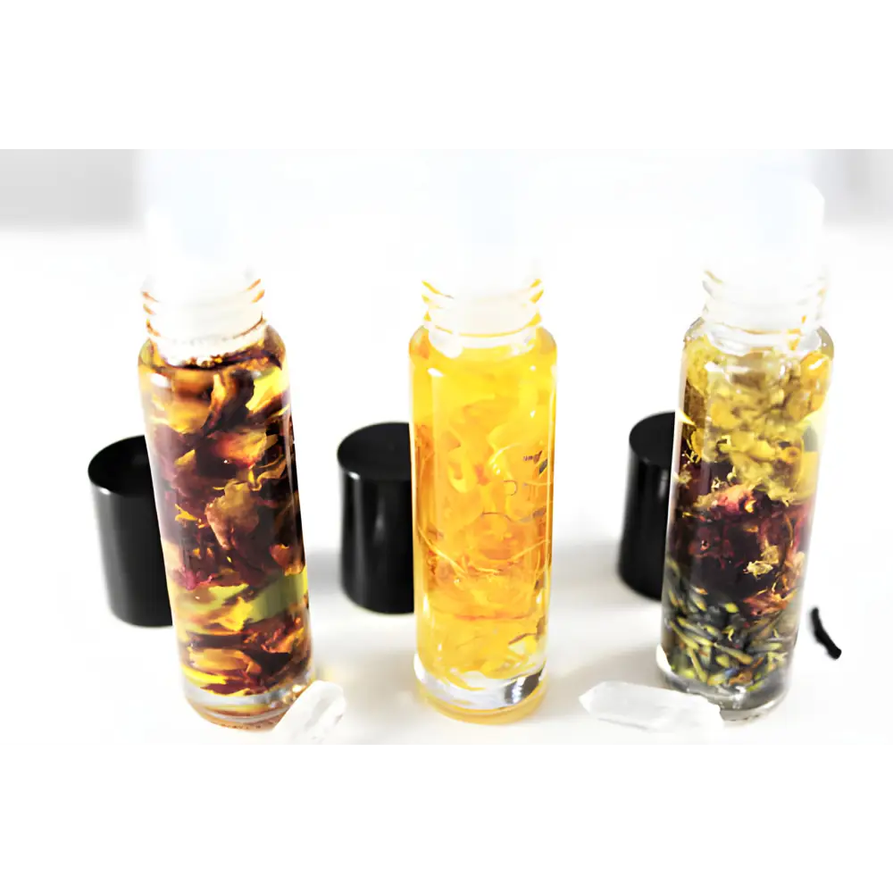 Three infused oil roller bottles of Blooming Botanical essential oil blend for natural fragrance