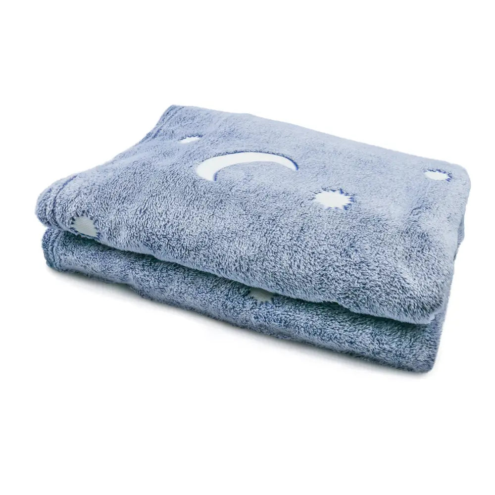 Folded blue towel with moon and star pattern for Blue Glow Cat Nap Pillow