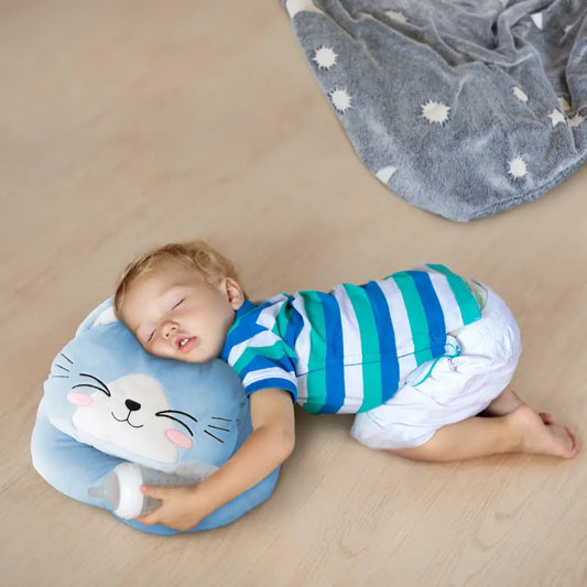 Sleeping toddler snuggles the Blue Glow Cat Nap Pillow shaped like a cute cat