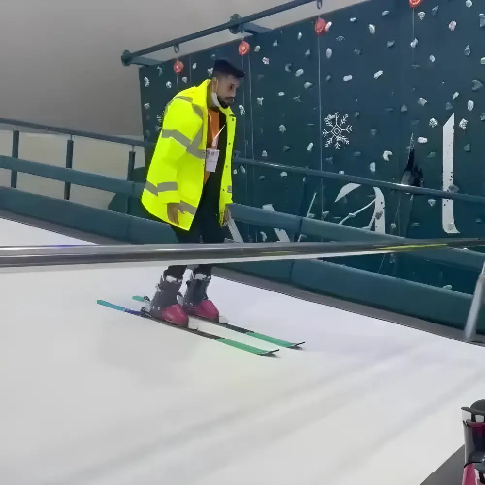 Man skiing indoors on a Tuocen Alpine Ski Machine for ultimate indoor fun