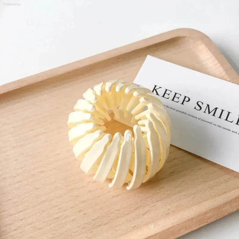 Beige bird’s nest hair clip.