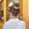 Hair bun with a woven clip.