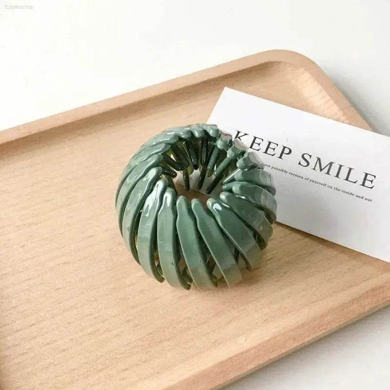Green bird’s nest hair clip.