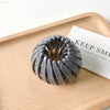 Gray bird’s nest hair clip.