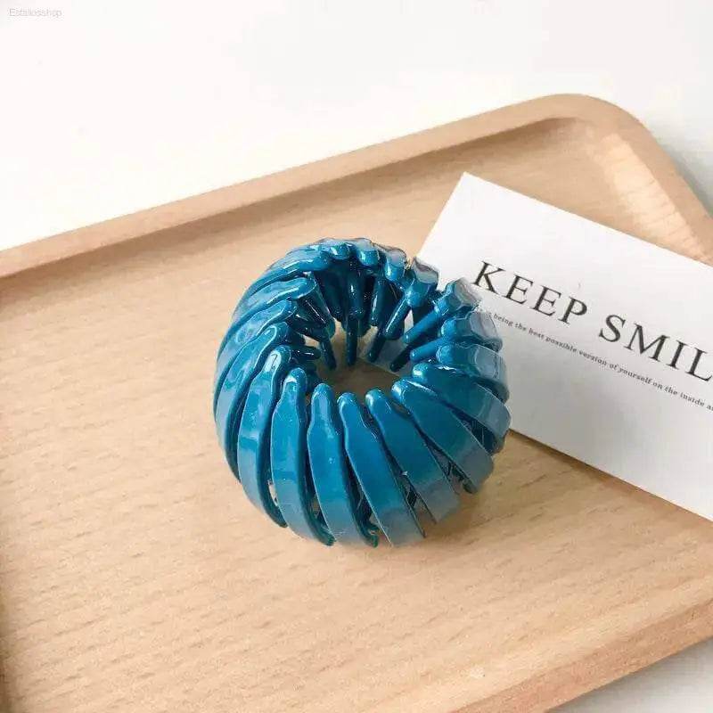 Teal bird’s nest hair clip.