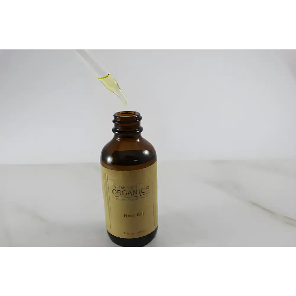 Amber glass bottle of Clary Sage Organic Hair Oil for effective hair oil repair