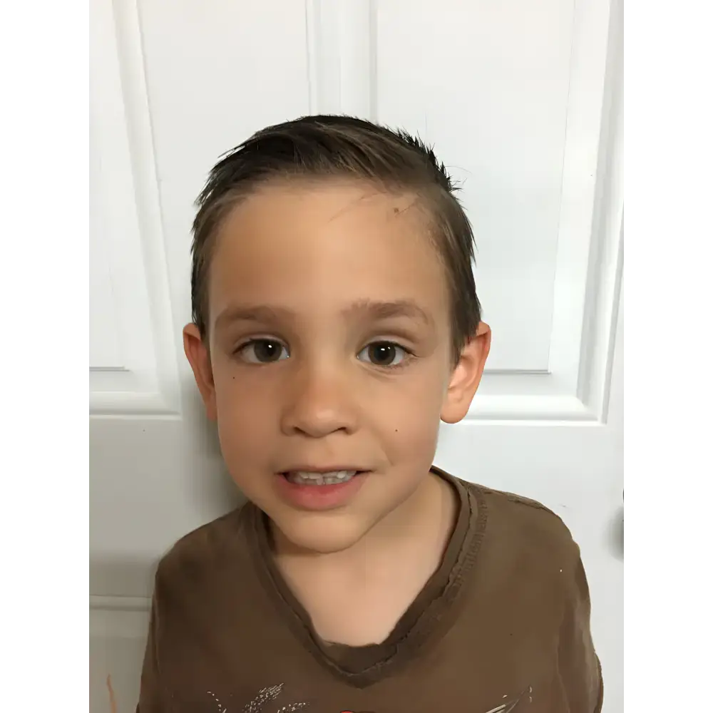 Young boy rocking styled hair with Cool Kid Organic Pomade Hair Wax for awesome looks