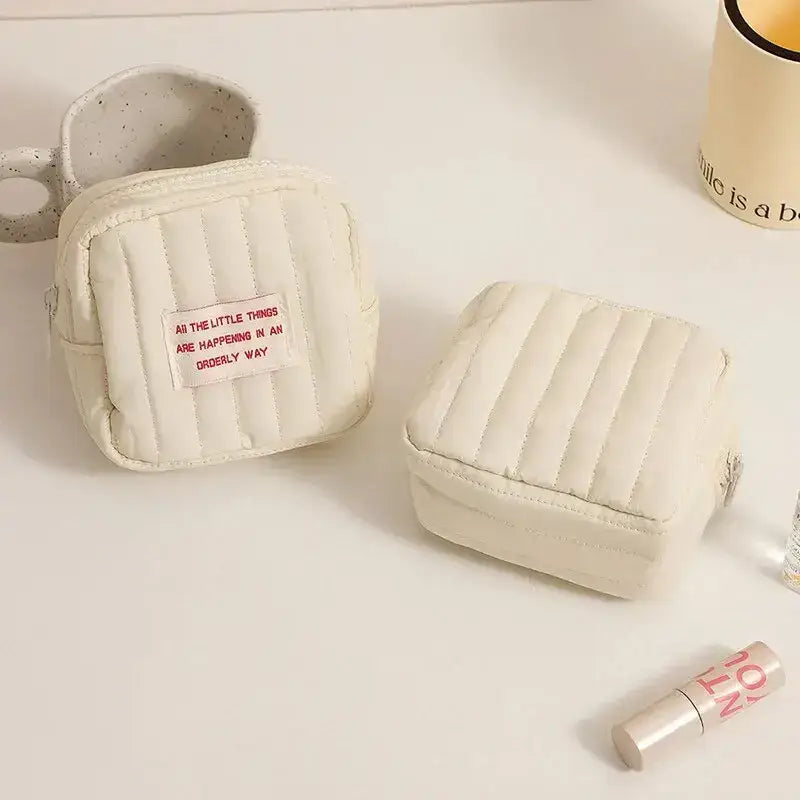 Two small, quilted off-white Korean square small makeup bags for stylish organization