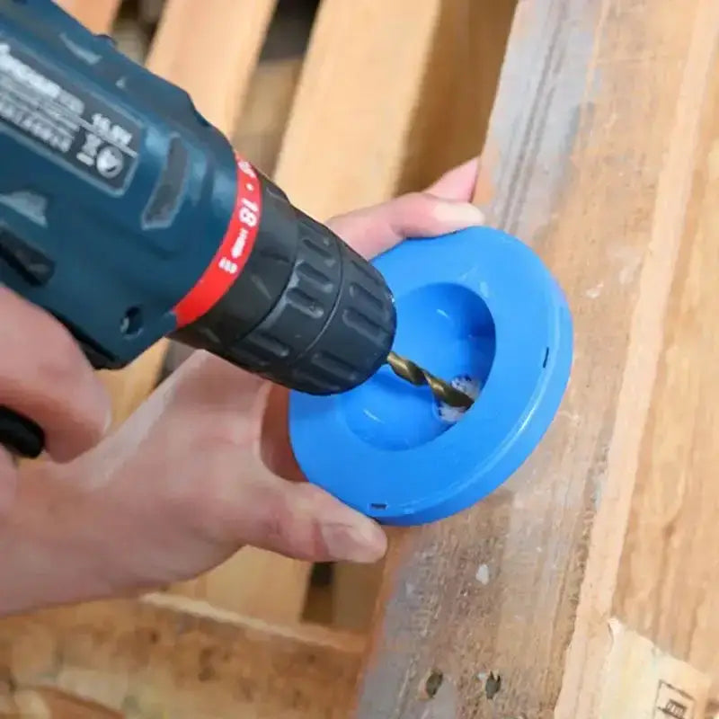 Blue plastic circular object in action with an electric hammer drill for less drill dust