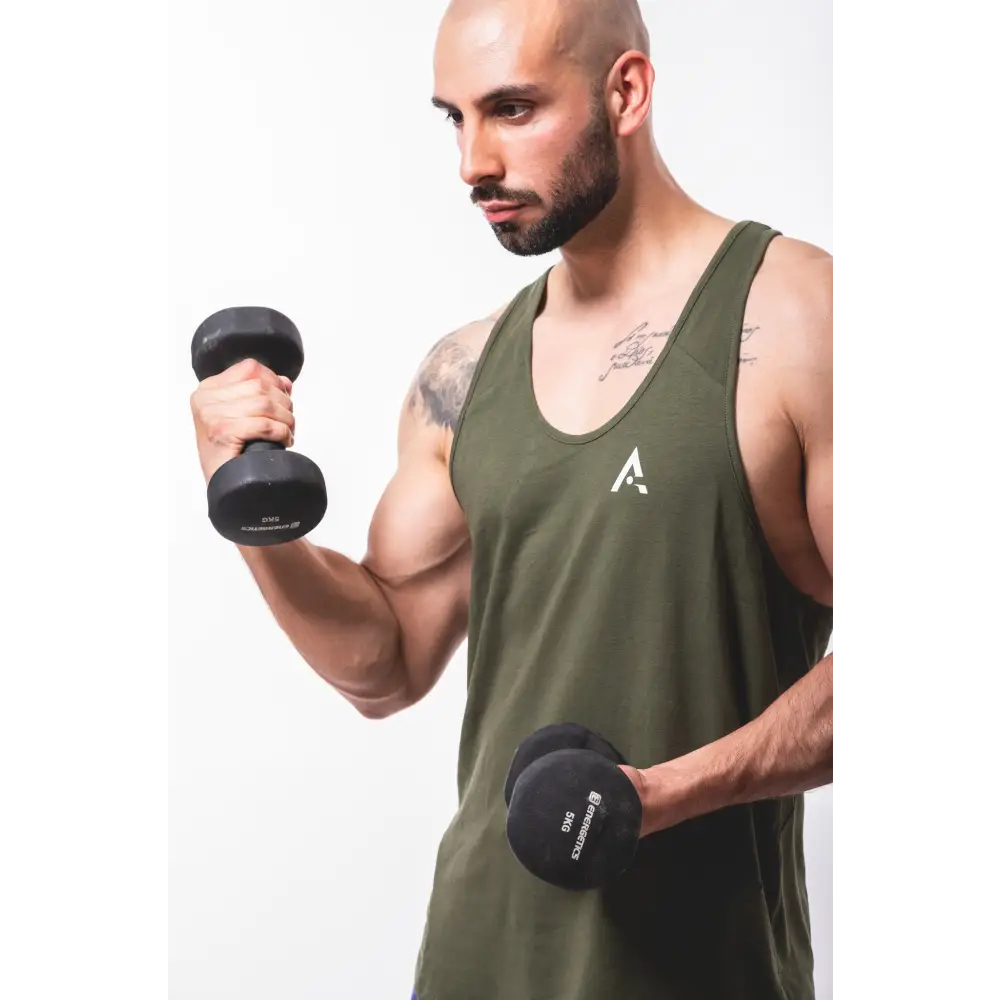 Man lifting dumbbells in a Mens Fitness Stringer for epic workout gains