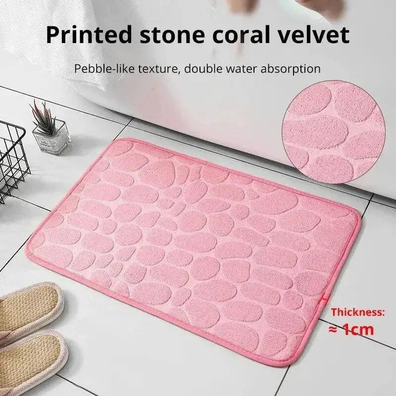 Pink pebble-patterned Cushy Embossed Velvet Bath Mat made of memory foam embossed material