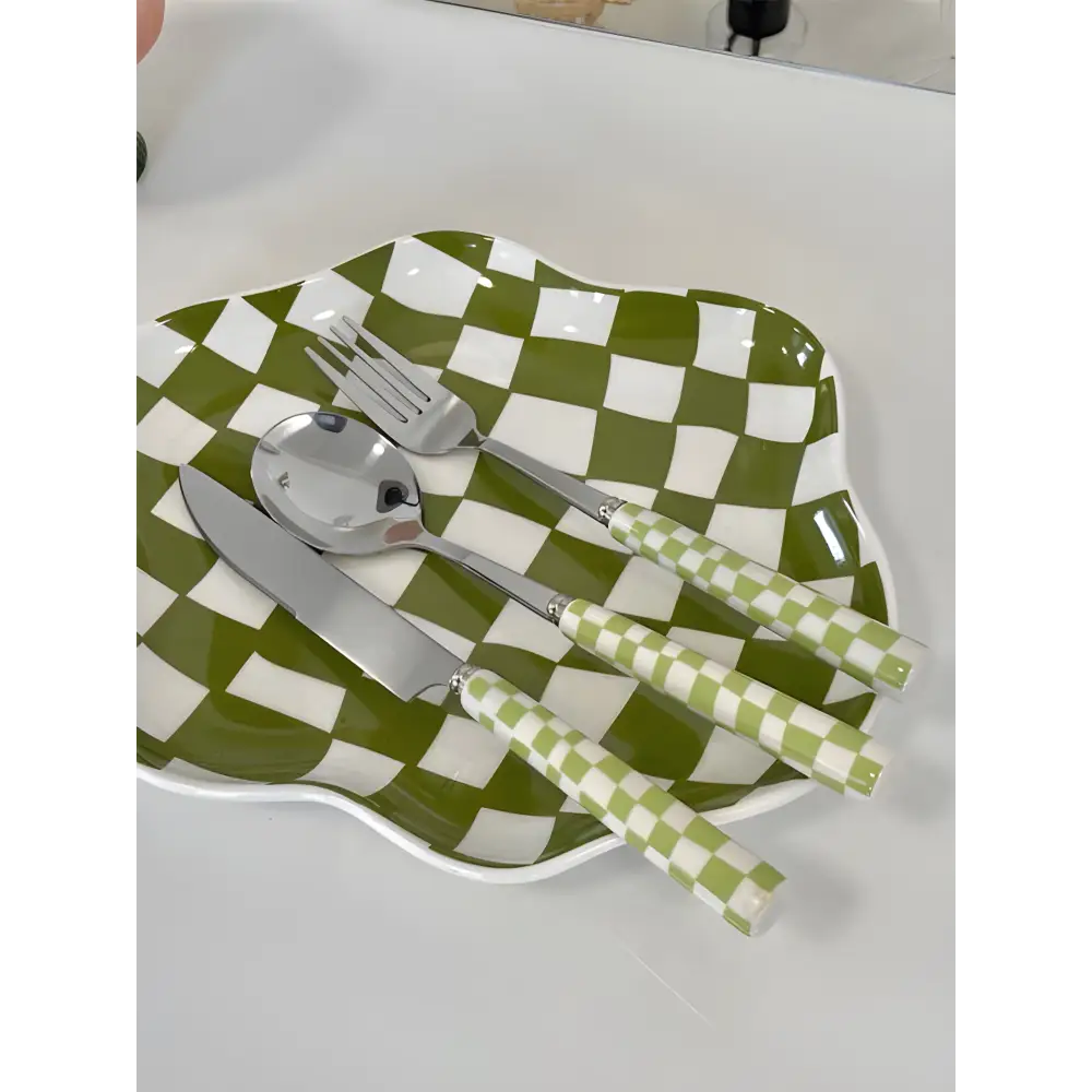 Green and white checkered plate with matching modern checkered flatware for cute dining