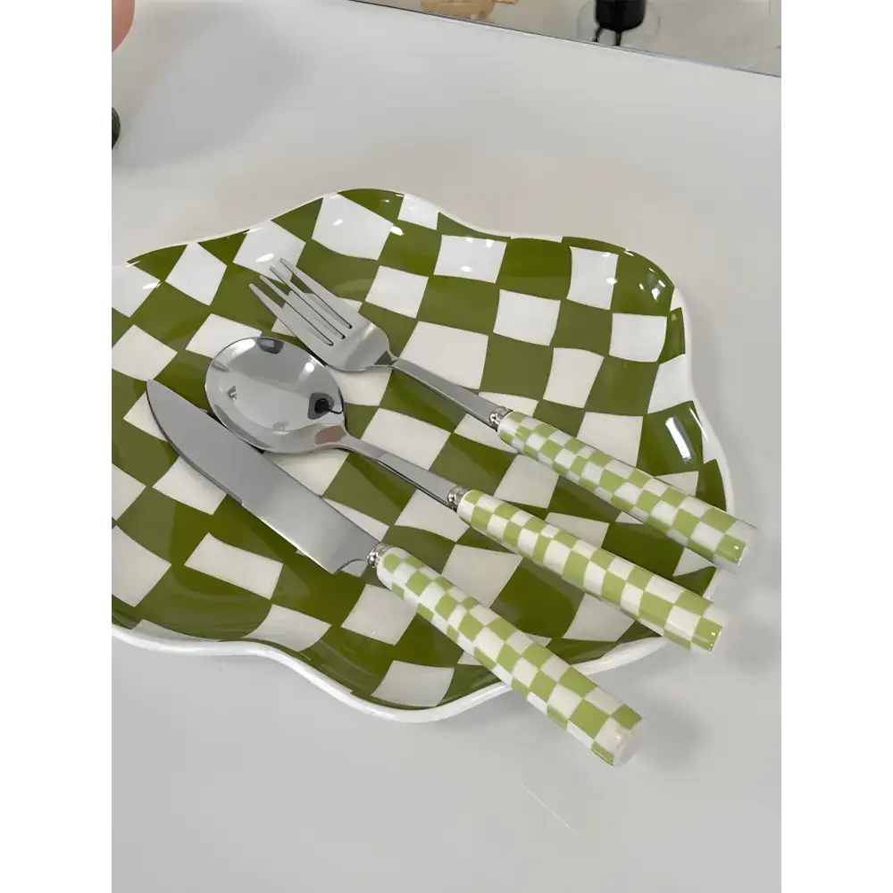 Green and white checkered plate with matching modern checkered flatware set