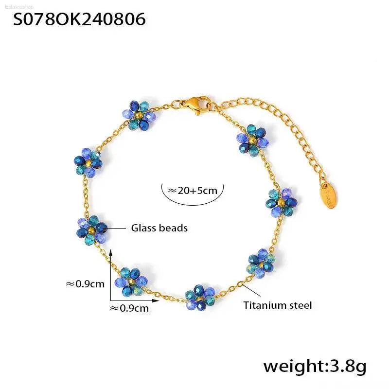 Gold-toned bracelet with blue glass flower beads.