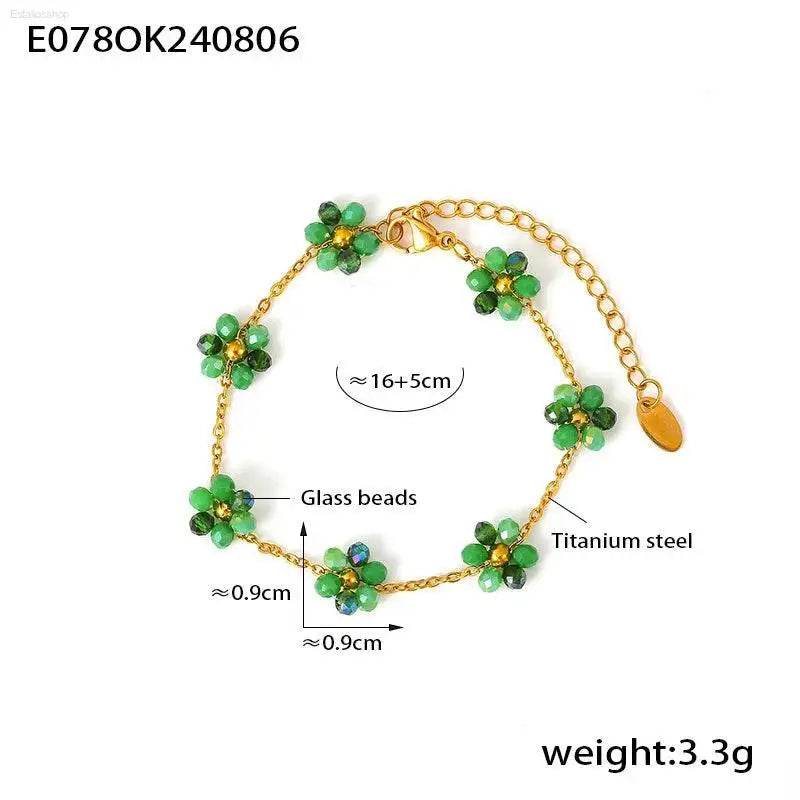 Gold-toned flower bracelet with green glass beads.