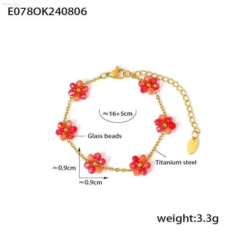 Gold-toned bracelet with red glass flower beads.