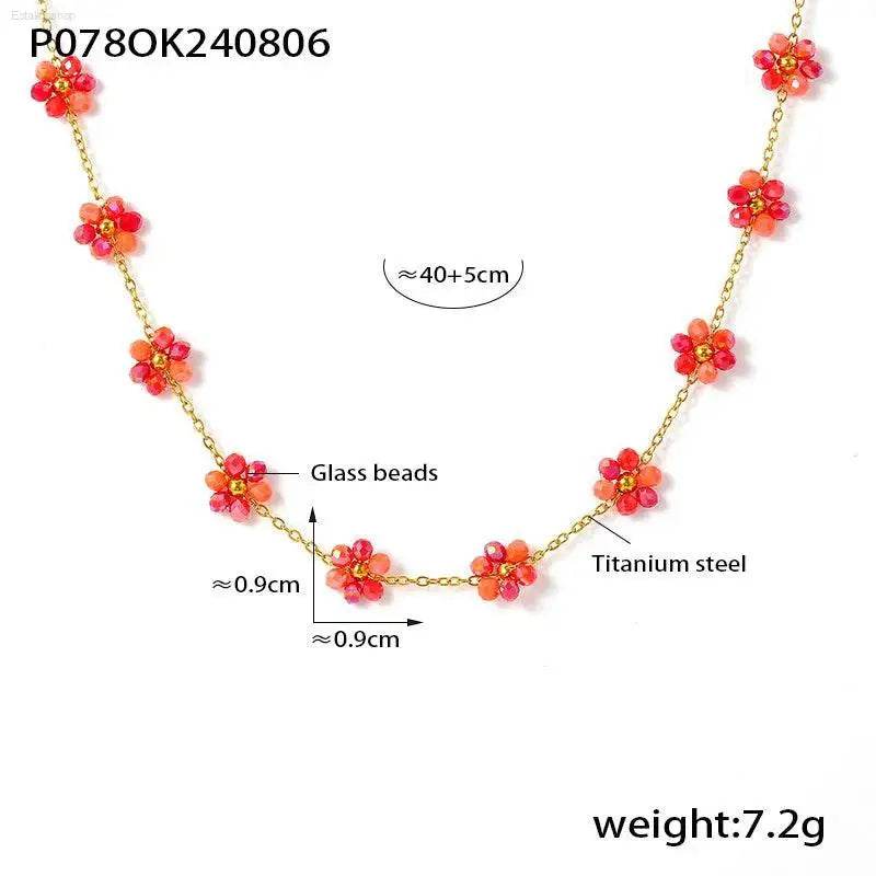 Gold-toned necklace with red glass bead flowers.