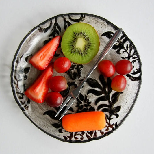 Fruit and carrot on Damask Black Velvet Gilded Glass Canapé Plate for elegant serving