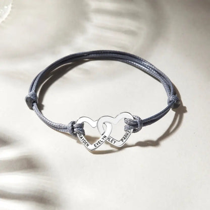 Gray cord grandma bracelet featuring cute interlocking heart charms in rose gold