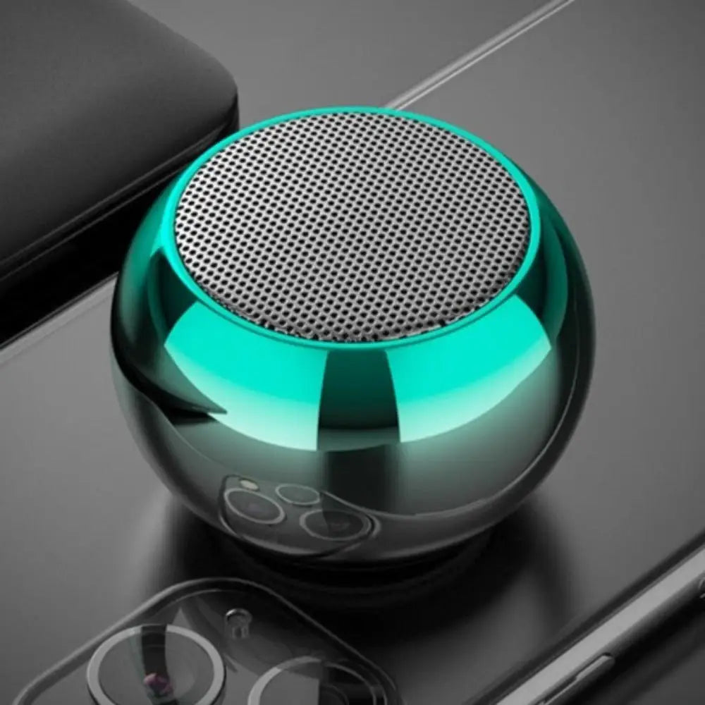 Round metallic Dragon Mini True Wireless Bluetooth speaker with teal accents